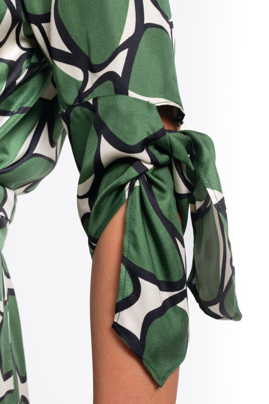 Feminine dress with shawl collar in a geometric green and offwhite vintage print in silk twill