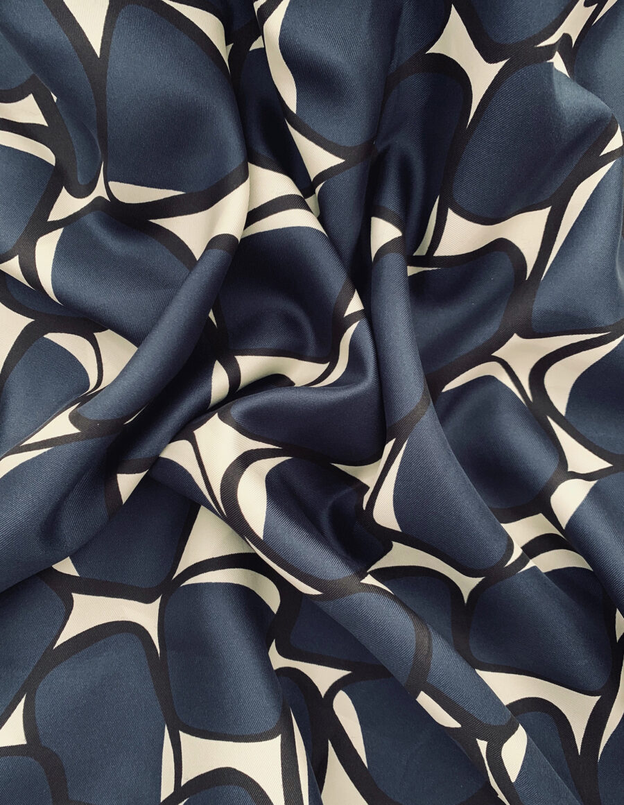 Feminine A-lined skirt in a geometric blue and white vintage print in silk twill