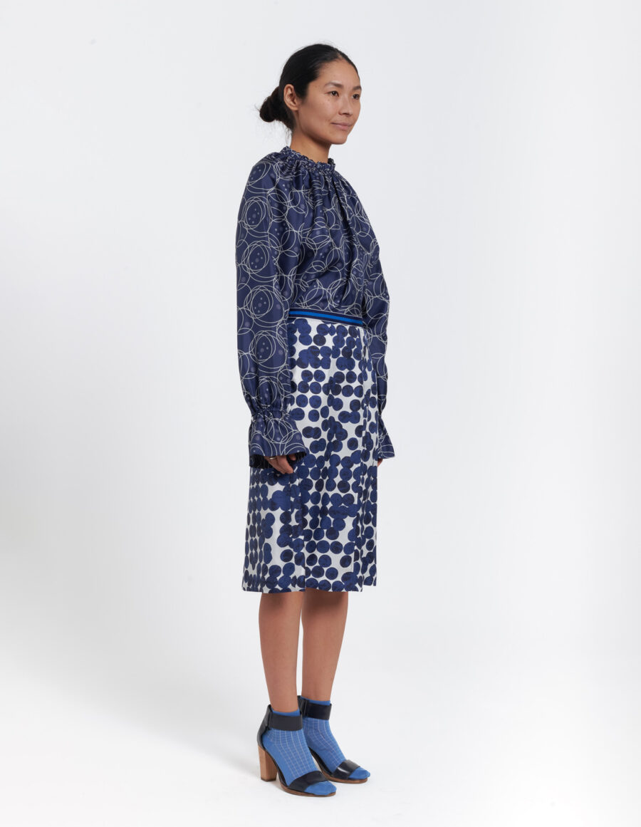 Longsleeved top with ruffled neckline in a geometric blue and white vintage print in silk twill