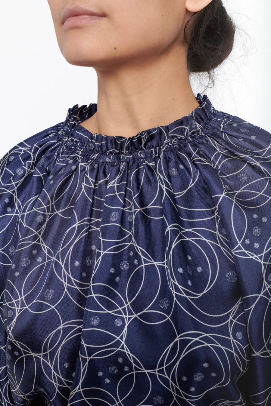 Longsleeved top with ruffled neckline in a geometric blue and white vintage print in silk twill